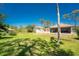 Spacious backyard showcasing the property's detached garage, landscaping, and well-kept lawn at 941 Allen Ave, Englewood, FL 34223