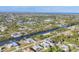 Expansive aerial view of the community with canals, homes, and lush landscaping stretching towards the horizon at 15184 Aldama Cir, Port Charlotte, FL 33981