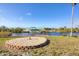 Spacious backyard with lush green grass, mature palm trees, a canal, and a covered boat lift at 15184 Aldama Cir, Port Charlotte, FL 33981
