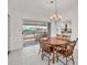 Bright dining room featuring tile flooring, natural light, and direct access to a kitchen and outdoor space at 15184 Aldama Cir, Port Charlotte, FL 33981