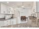 Bright kitchen featuring white cabinets, granite countertops, and modern appliances; dining area visible at 15184 Aldama Cir, Port Charlotte, FL 33981