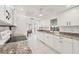 Modern kitchen features white cabinets, granite countertops, and white tile flooring at 15184 Aldama Cir, Port Charlotte, FL 33981