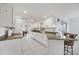 Modern kitchen featuring white cabinets, granite countertops, and tile flooring, perfect for cooking and entertaining at 15184 Aldama Cir, Port Charlotte, FL 33981