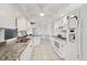 Well-lit kitchen with white cabinets, granite countertops, and stainless steel appliances at 15184 Aldama Cir, Port Charlotte, FL 33981