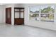Bright living room with tile floors, corner cabinet and a large window offering plenty of natural light at 15184 Aldama Cir, Port Charlotte, FL 33981