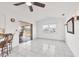 Living Room with tile floors, ceiling fan, and sliding glass doors to an outdoor space at 15184 Aldama Cir, Port Charlotte, FL 33981