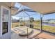 Covered and screened patio with tile floors, and a hot tub overlooking a canal at 15184 Aldama Cir, Port Charlotte, FL 33981