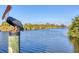 Waterfront view with pelican post ornament at 15184 Aldama Cir, Port Charlotte, FL 33981