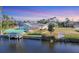 Waterfront property with boat dock and lift, offering direct access to the water for boating and recreation at 15184 Aldama Cir, Port Charlotte, FL 33981