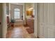 Well-lit bathroom featuring double sinks, bathtub, tiled floors, and a decorative window at 1078 Boundary Blvd, Rotonda West, FL 33947