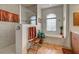 Bathroom showcasing a glass shower, bathtub with window, and warm-toned tile floors at 1078 Boundary Blvd, Rotonda West, FL 33947
