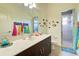 Well-lit bathroom featuring a large vanity, decorative fish and glass enclosed shower at 1078 Boundary Blvd, Rotonda West, FL 33947