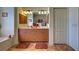 Bathroom with double sink vanity, decorative lighting, bathtub, and tiled floors at 1078 Boundary Blvd, Rotonda West, FL 33947