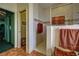 Tiled shower area with glass door, view of bathtub, and doorway to closet at 1078 Boundary Blvd, Rotonda West, FL 33947