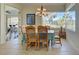 The dining area features a large window, chandelier lighting, and an open view of the kitchen at 1078 Boundary Blvd, Rotonda West, FL 33947