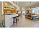 Open floorplan showcasing kitchen barstool seating and a chandelier-lit dining table at 1078 Boundary Blvd, Rotonda West, FL 33947