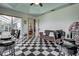 Entertainment room features a jukebox, bar, and checkered floors at 1078 Boundary Blvd, Rotonda West, FL 33947
