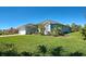 Well-maintained single-story home featuring an attached garage, beautiful lawn, and mature trees at 1078 Boundary Blvd, Rotonda West, FL 33947