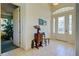 Bright foyer features tile flooring, decorative glass door, and stylish accent furniture at 1078 Boundary Blvd, Rotonda West, FL 33947