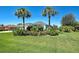 Lush landscaping frames this appealing single-story home with swaying palm trees and verdant lawn at 1078 Boundary Blvd, Rotonda West, FL 33947