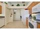Functional kitchen showcasing a white oven and refrigerator, wood cabinets, and a pantry at 1078 Boundary Blvd, Rotonda West, FL 33947