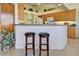 Bright kitchen with a breakfast bar, wood cabinetry, and modern appliances at 1078 Boundary Blvd, Rotonda West, FL 33947