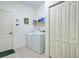 Functional laundry room with washer, dryer, storage cabinets, and tile flooring at 1078 Boundary Blvd, Rotonda West, FL 33947