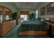 Beautiful green main bedroom with tray ceiling, art, and furniture at 1078 Boundary Blvd, Rotonda West, FL 33947