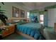 Green main bedroom filled with tropical plants and art at 1078 Boundary Blvd, Rotonda West, FL 33947