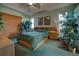 Main bedroom with green walls, carpet, tray ceiling, and furniture at 1078 Boundary Blvd, Rotonda West, FL 33947
