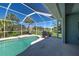 Beautiful screened-in pool with scenic backyard views, perfect for relaxing and entertaining at 1078 Boundary Blvd, Rotonda West, FL 33947