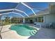 Backyard swimming pool with screen enclosure, patio, and outdoor seating, ideal for leisure at 1078 Boundary Blvd, Rotonda West, FL 33947