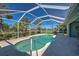 Sparkling pool enclosed by a screen, offering privacy and a clear view of the sky at 1078 Boundary Blvd, Rotonda West, FL 33947