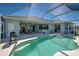 View of the pool and backyard with outdoor grill and seating, creating an inviting atmosphere at 1078 Boundary Blvd, Rotonda West, FL 33947