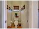 Cozy powder room with toilet, window, and decoratively framed wall art at 1078 Boundary Blvd, Rotonda West, FL 33947