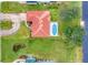Aerial view of the home showcasing the backyard pool and well-manicured landscaping at 1080 Boundary Blvd, Rotonda West, FL 33947