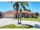 Inviting single-story home with a well-manicured lawn and circular driveway at 1080 Boundary Blvd, Rotonda West, FL 33947