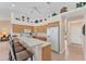 Spacious kitchen with wooden cabinets, modern appliances, tiled floors, and an open layout with decorative shelving at 1080 Boundary Blvd, Rotonda West, FL 33947
