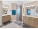 Bright bathroom with double sinks, tile flooring, walk-in shower, and an open layout at 1080 Boundary Blvd, Rotonda West, FL 33947