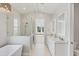 Spacious bathroom with double vanity, glass shower and tub at 1141 Andrews St, Englewood, FL 34224