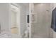 Bright bathroom showcasing a glass shower, commode, and access to another room at 1141 Andrews St, Englewood, FL 34224