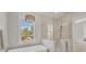 Stylish primary bath with a soaking tub and a separate glass shower at 1141 Andrews St, Englewood, FL 34224