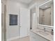 Bright bathroom featuring a glass shower, neutral tile flooring, and a sleek illuminated vanity mirror at 1141 Andrews St, Englewood, FL 34224