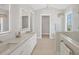 Bright primary bath with double vanity, LED mirrors, and step-in shower at 1141 Andrews St, Englewood, FL 34224