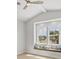 Cozy bedroom with window seat, pillows, and fan at 1141 Andrews St, Englewood, FL 34224