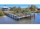 Long dock with rope railings, boat lift, and steps into the water at 1141 Andrews St, Englewood, FL 34224