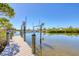 Wooden dock with a boat lift leads out to the water at 1141 Andrews St, Englewood, FL 34224