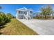 Inviting two-story home with a metal roof, double garage, and ample outdoor space at 1141 Andrews St, Englewood, FL 34224