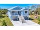 Inviting exterior of a blue two-story home with a metal roof and double garage at 1141 Andrews St, Englewood, FL 34224