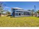 Wide, ground level view of house featuring a large screened in pool at 1141 Andrews St, Englewood, FL 34224